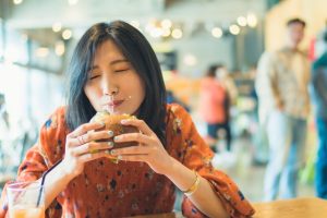 ハンバーガーを食べる女性
